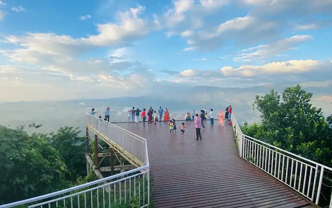 Mullanpara scenic viewpoint near JKR Gardens Resort, Kerala: panoramic clifftop view of lush green hills, valleys, and misty forests, ideal for photography and trekking. No visible text.