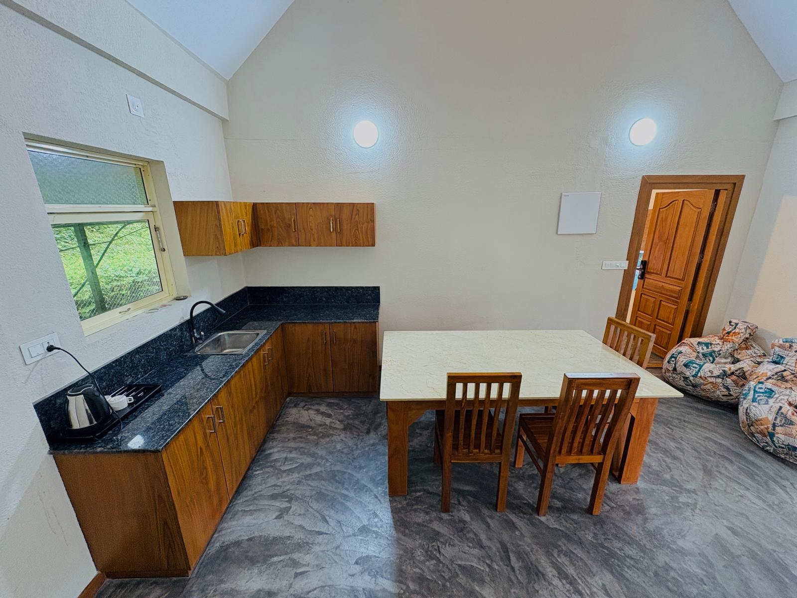 Executive room at JKR Gardens Resort Kerala with modern decor, king-size bed, ambient lighting, and luxury amenities