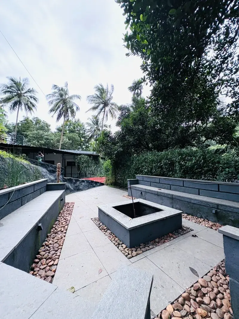 Palm-fringed walkway at Vayalada Gardens Resort