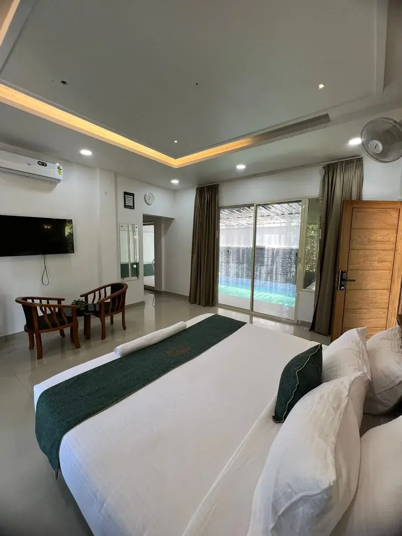 Room with pool view through glass door