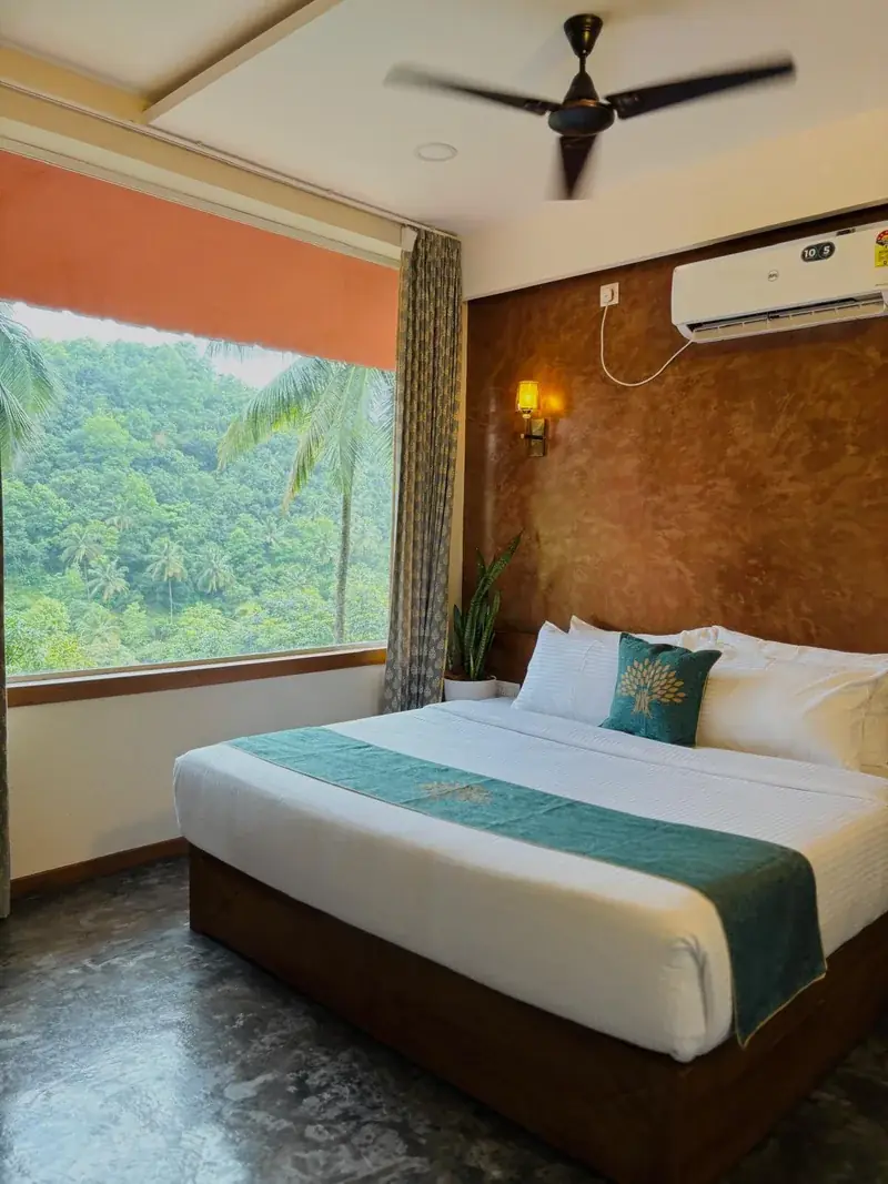 Room with large window onto hills