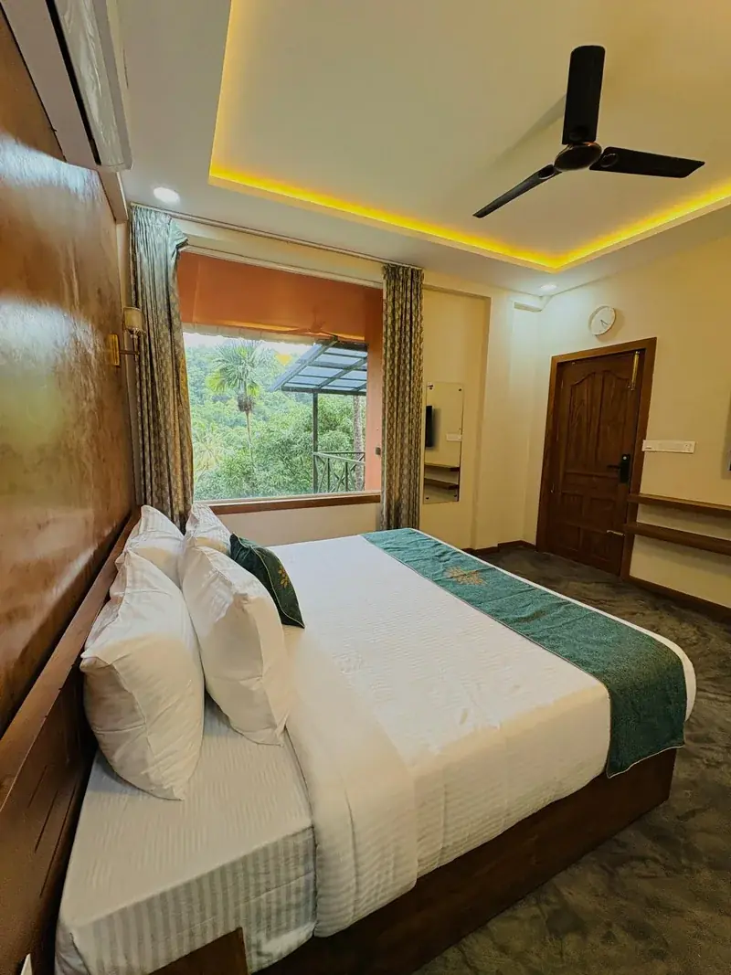 Family suite bedroom with forest view at Vayalada Gardens Resort