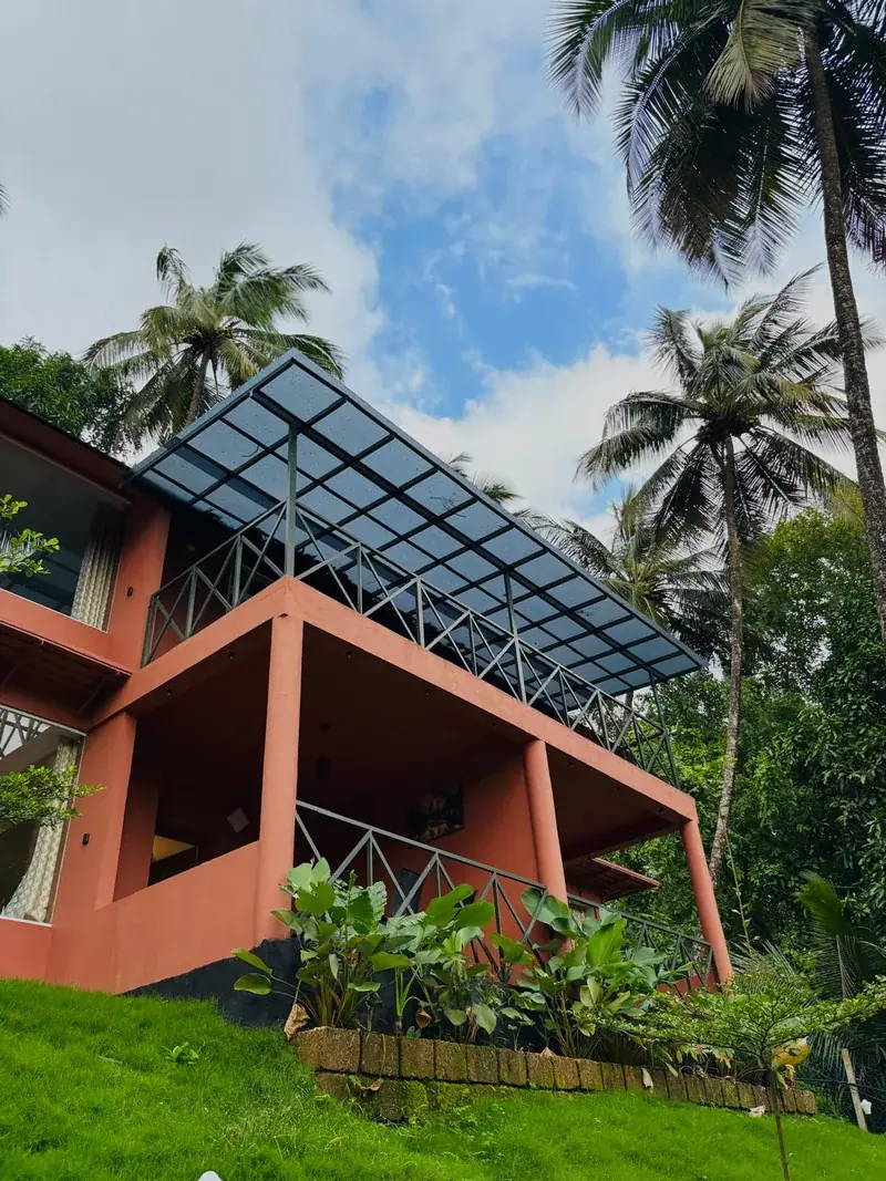 Glass roof over the terrace among palms