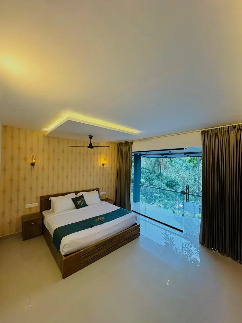 Room with cove lighting and forest window