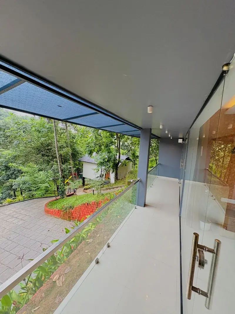 Glass terrace overlooking forest trees