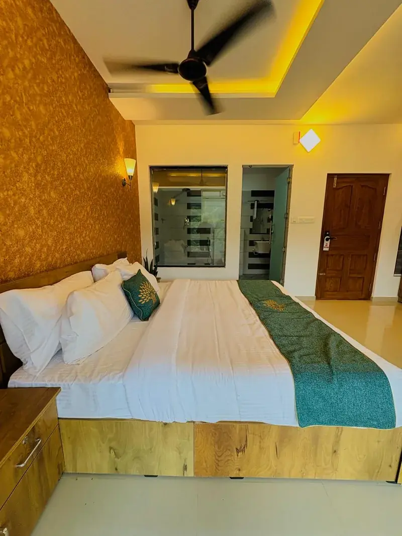 Suite room with king bed and cane wall at Vayalada Gardens Resort