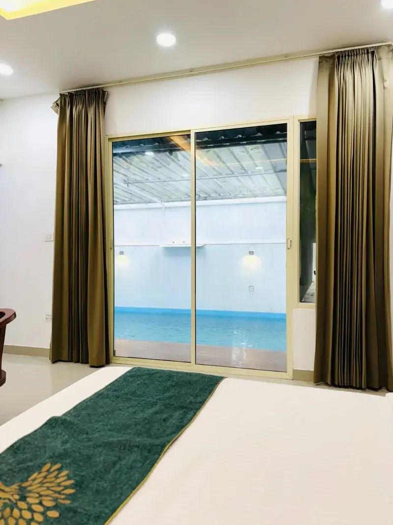 Pool glimpsed through glass doors in the pool villa