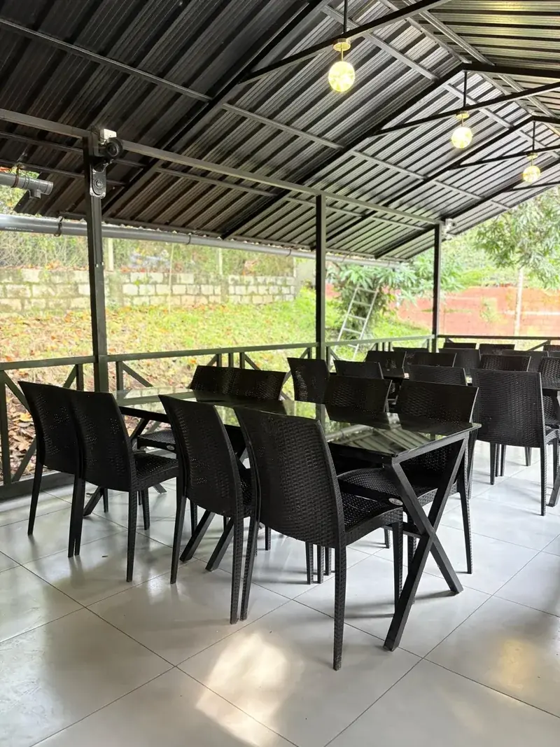 Open-air restaurant with forest view at Vayalada Gardens Resort